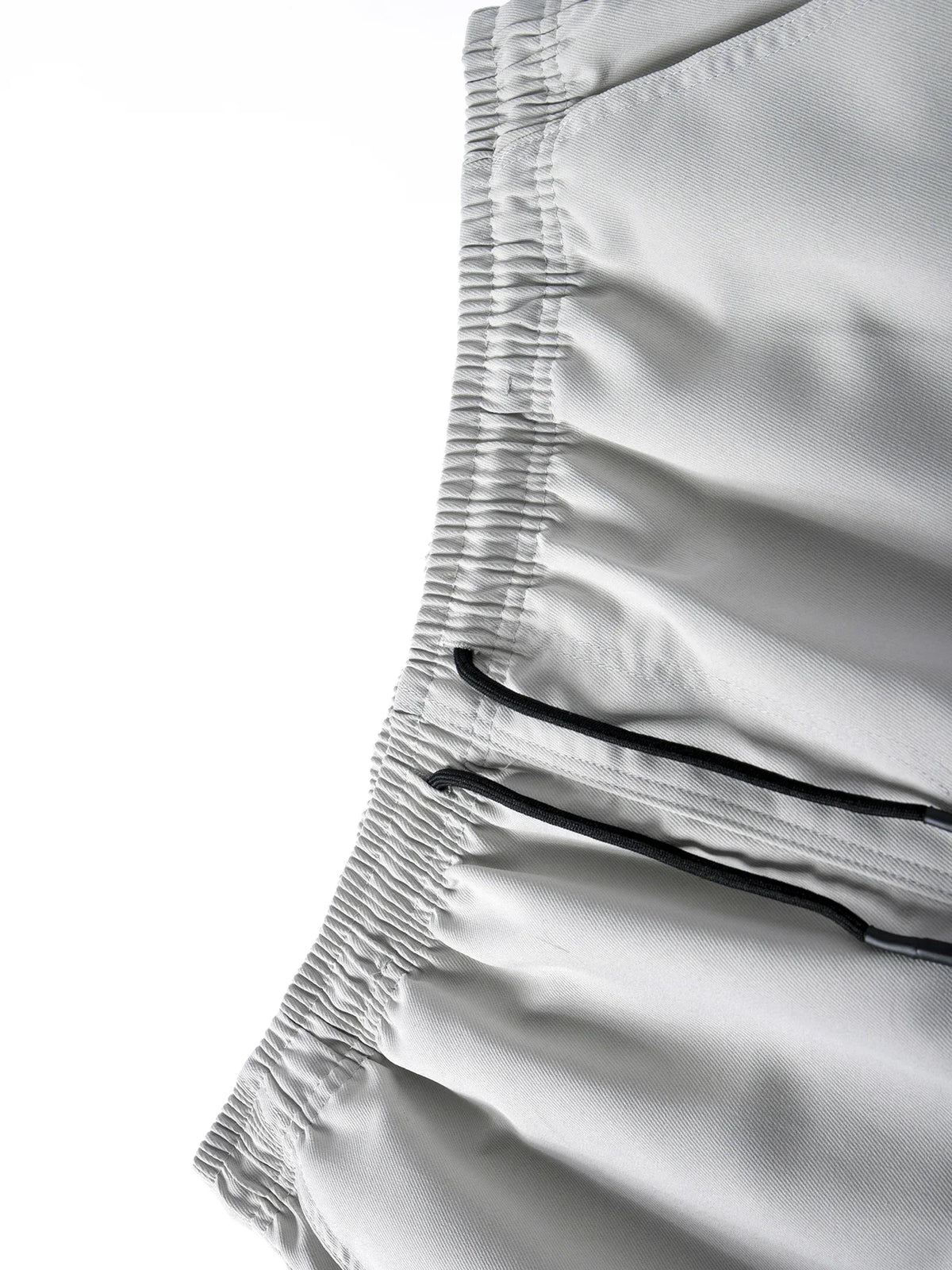 Close-up of the elastic waistband and drawstring closure of men's cargo joggers.