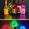 Five bottles of Secolulu liquor illuminated by colorful LED fairy lights