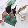 A collection of seamless U-back bralettes in various shades of pink, green, and black are displayed on a white background.