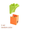A set of green marble run building blocks with funnels and tracks.