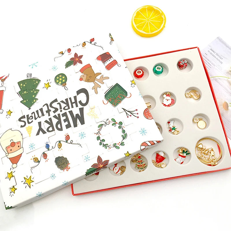 A white advent calendar box with compartments filled with charm bracelets and a slice of lemon.