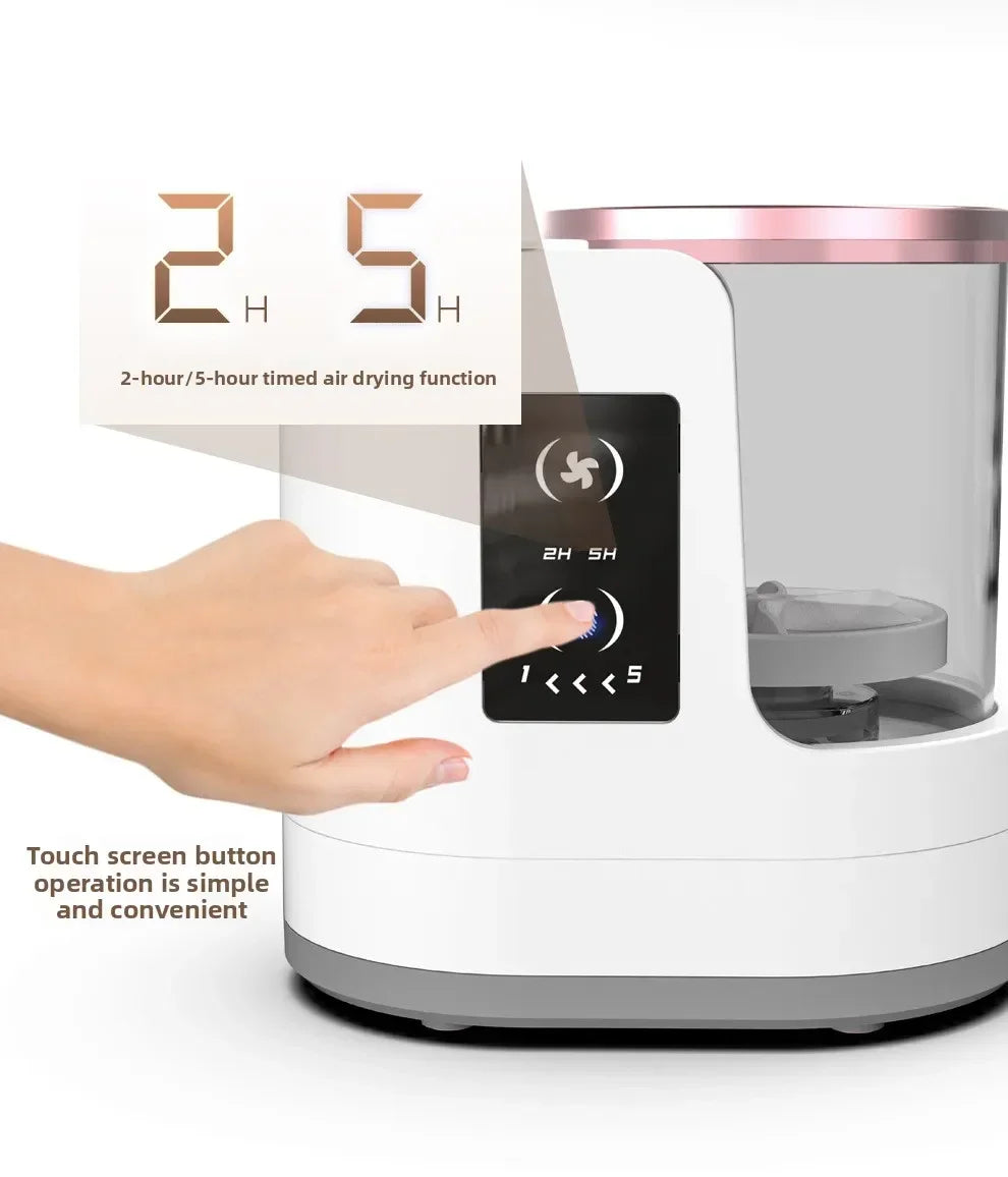 A hand is operating a white electric makeup brush cleaner with a touch screen display showing 2H or 5H timed air drying funct