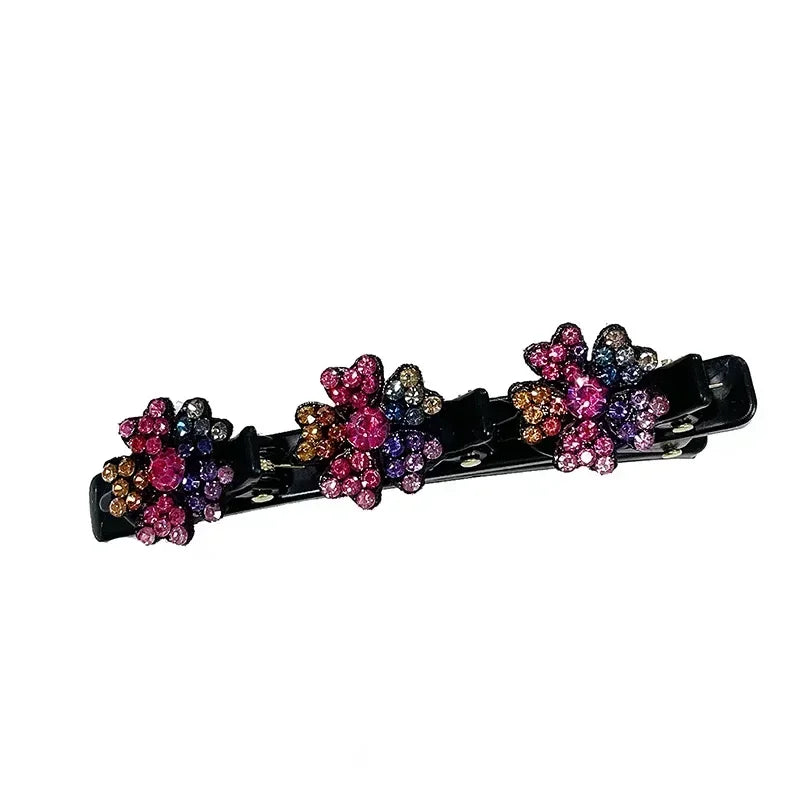 Clip de pelo negro con adornos florales morados y rosados