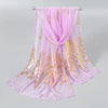 A sheer pink chiffon scarf and head wrap with gold shimmer detailing displayed on a hanger.