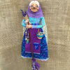 Handcrafted kitchen witch doll wearing a purple and teal dress with a white headdress