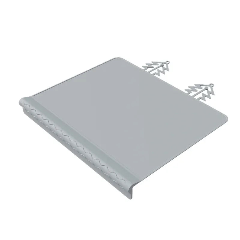 A gray silicone feeding placemat with a teething edge and mounting tabs.