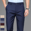 Navy blue men's stretch straight-leg trousers with a light blue shirt and a wrist watch