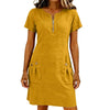 A woman wearing a mustard yellow lightweight cotton-linen short sleeve dress with a zippered collar and front pockets.