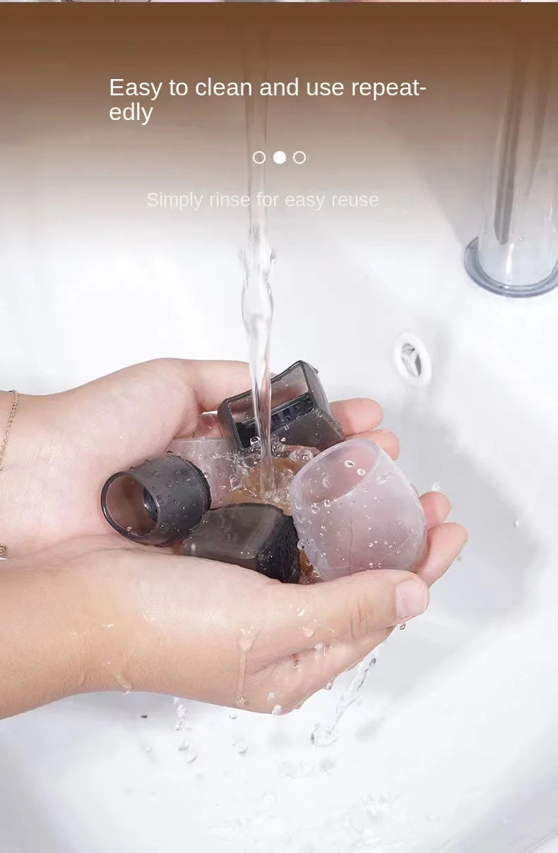 Hands hold silicone furniture leg pads with felt bottoms being rinsed under water.