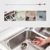 A hand is using a flexible drain snake cleaner to clear a clogged sink drain.