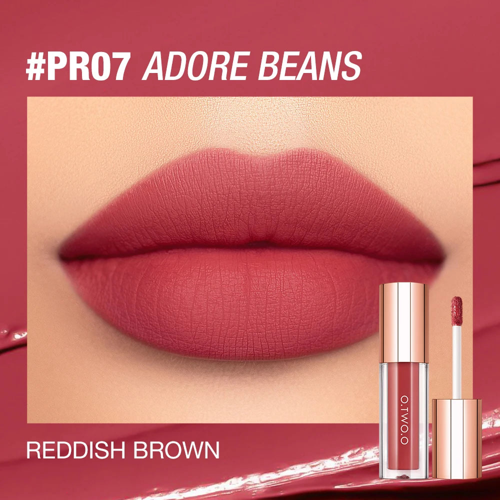 A close-up of a reddish brown matte lip tint product in a glass tube against a pink background.