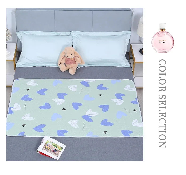 Light blue and green patterned waterproof baby mattress protector with a cute cartoon elephant design