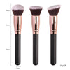 A set of three professional makeup brushes with rose gold handles and fluffy bristles for foundation, concealer, and blush ap