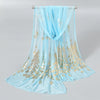 Light blue gold shimmer chiffon scarf and head wrap displayed on a hanger.