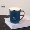 A blue 350ml stainless steel insulated travel mug with a white lid resting on a white book.