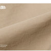 A close-up view of a tan professional sunscreen product labeled 01, showing a textured fabric surface.