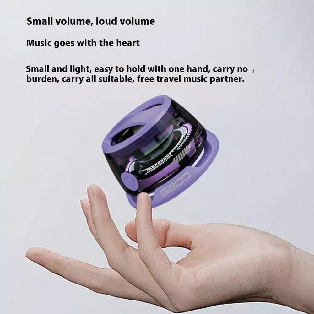 A hand holds a small, purple magnetic transparent Bluetooth speaker with RGB lighting.